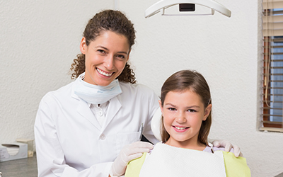 Little girl smiling with a dentist