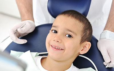 A child sitting in a dental chair